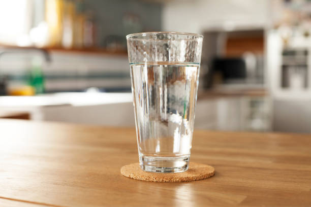 A glass of water on a kitchen table